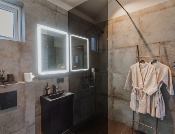 Backlight Mirror at wellness retreat rainfall shower with Icelandic water in back