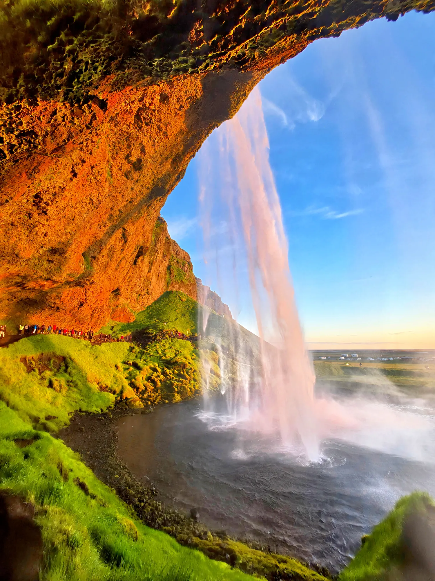 View from the path behind Seljalandsfoss waterfall on a summer evening