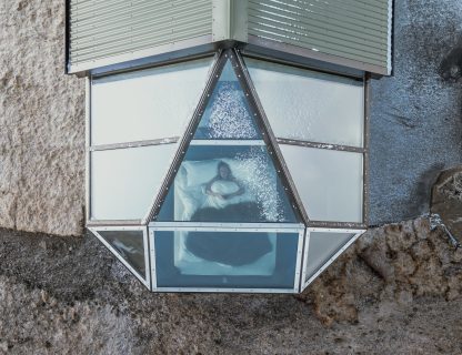 Glass igloo views of the night sky Iceland next to Skógafoss