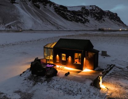 Night-time view at wellness retreat at Sky retreat Iceland next to Skógafoss